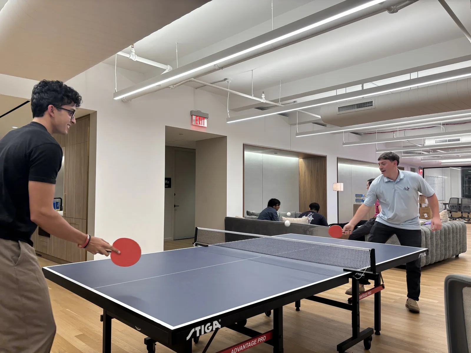 Sapien teammates playing ping pong in the office