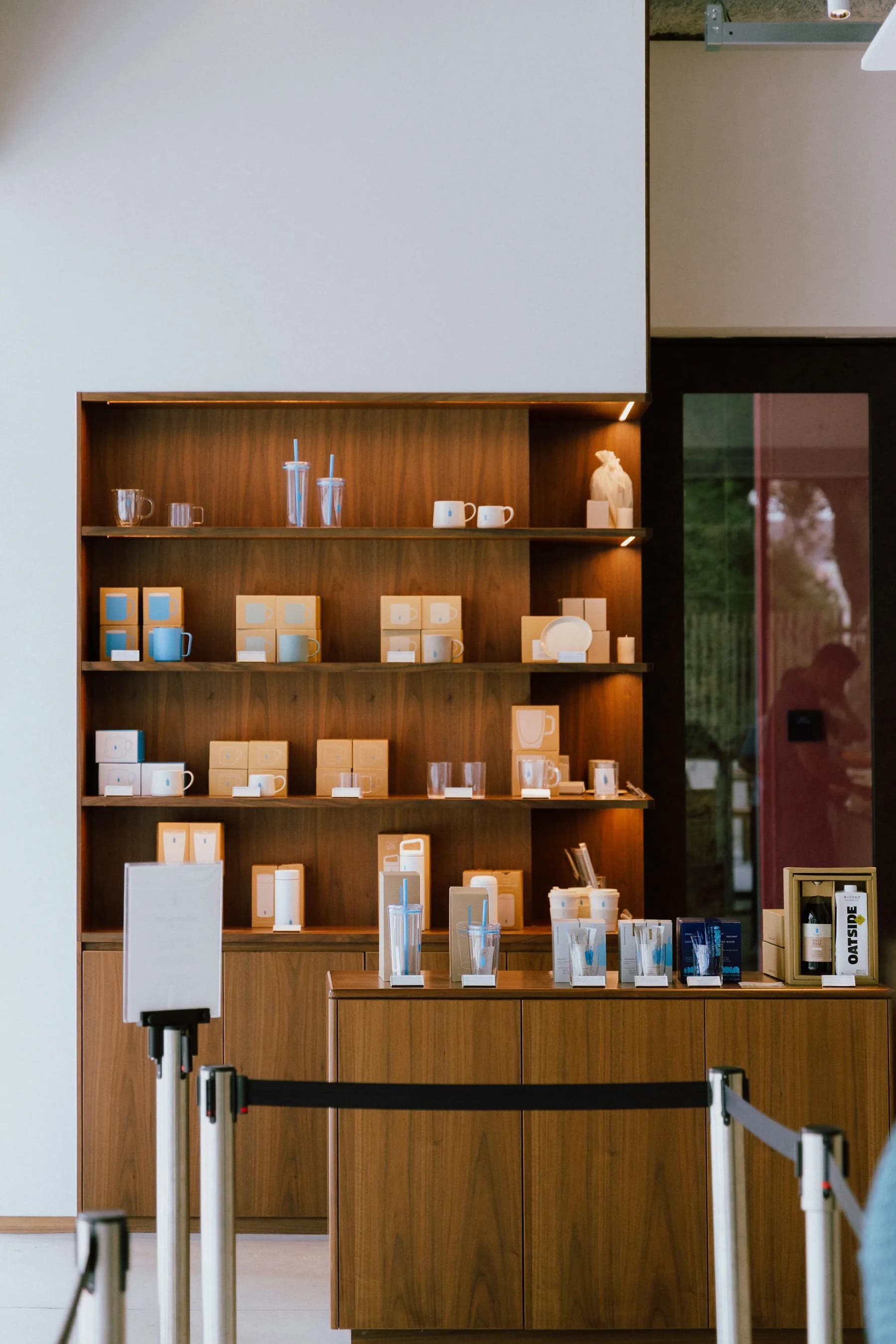 Branded drinkware and packaged goods on modern wooden retail shelving