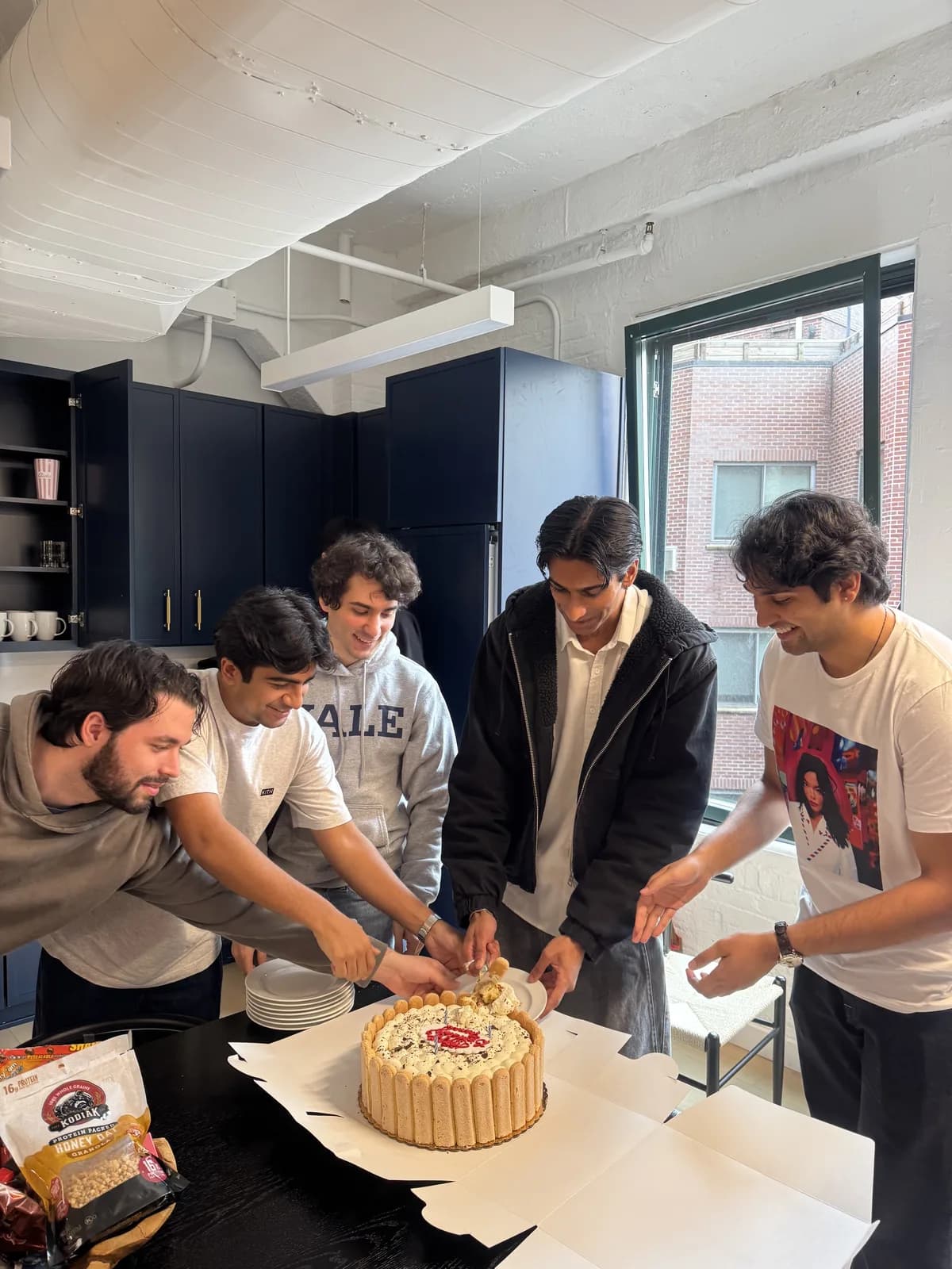 Sapien teammates sharing birthday cake in the office