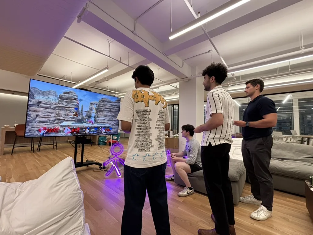 Sapien teammates playing a video game in the office