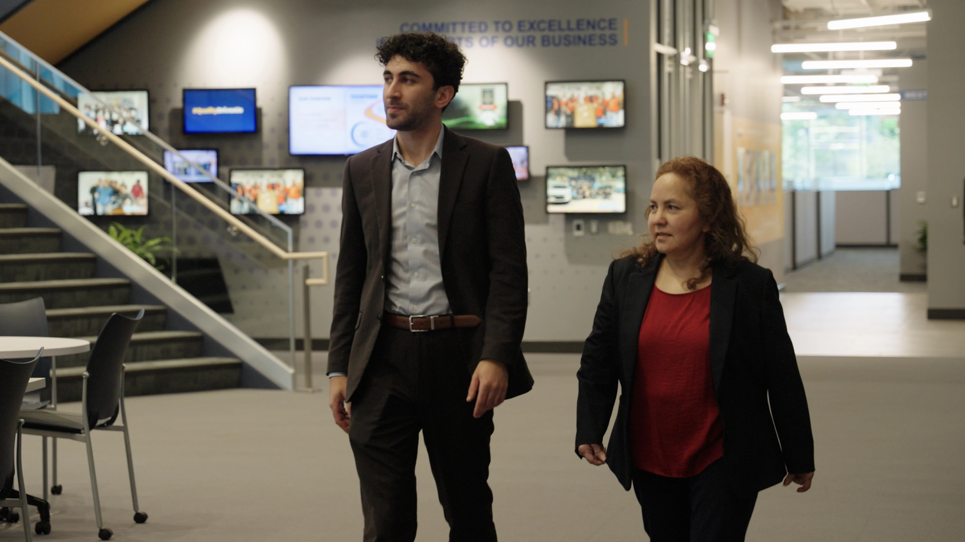 Patricia Dominguez and Ron Nachum walking through Cooper Standard's lobby