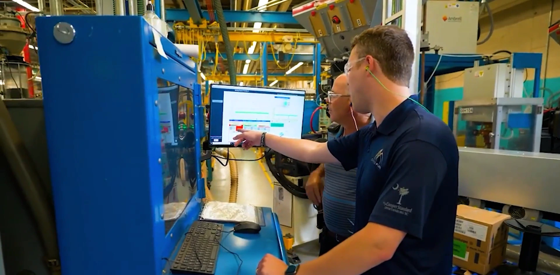 Cooper Standard employees reviewing a production workstation on the factory floor